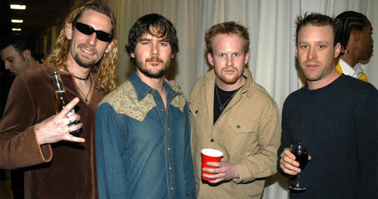 Your Favorite Band Sucks gift card joke photo: four guys posing with drinks at a party