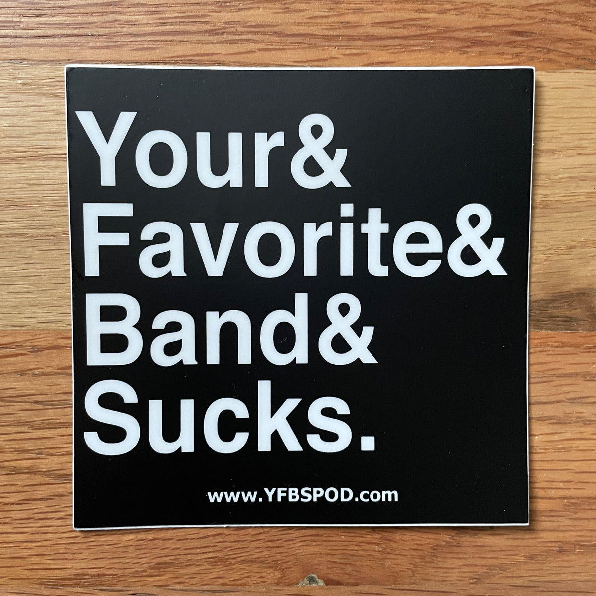 Your Favorite Band Sucks Ampersand Sticker, black 4x4 inch vinyl sticker with white 'Your& Favorite& Band& Sucks.' text