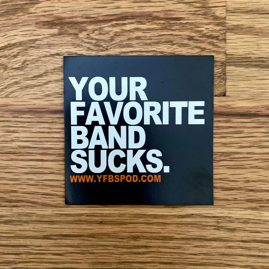 Your Favorite Band Sucks Magnet, black 3x3 inch square magnet with white lettering on a wood surface
