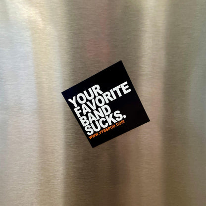 Your Favorite Band Sucks Magnet stuck at an angle on a stainless steel refrigerator door