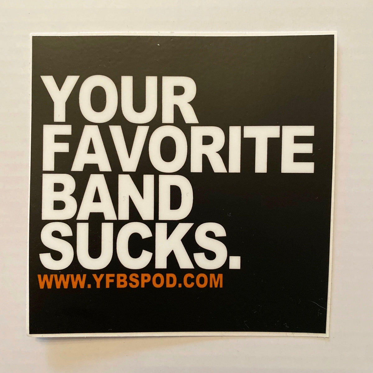 Your Favorite Band Sucks Sticker, black 4x4 inch vinyl sticker with white YFBS logo lettering